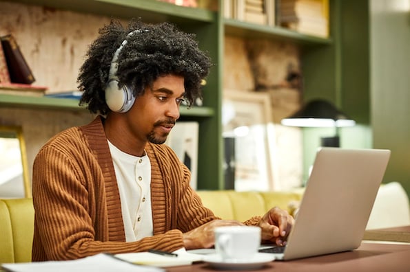 Man looking at conference website homepages to get design ideas